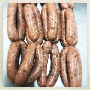 Rows of linked Rabbit and tarragon sausages.