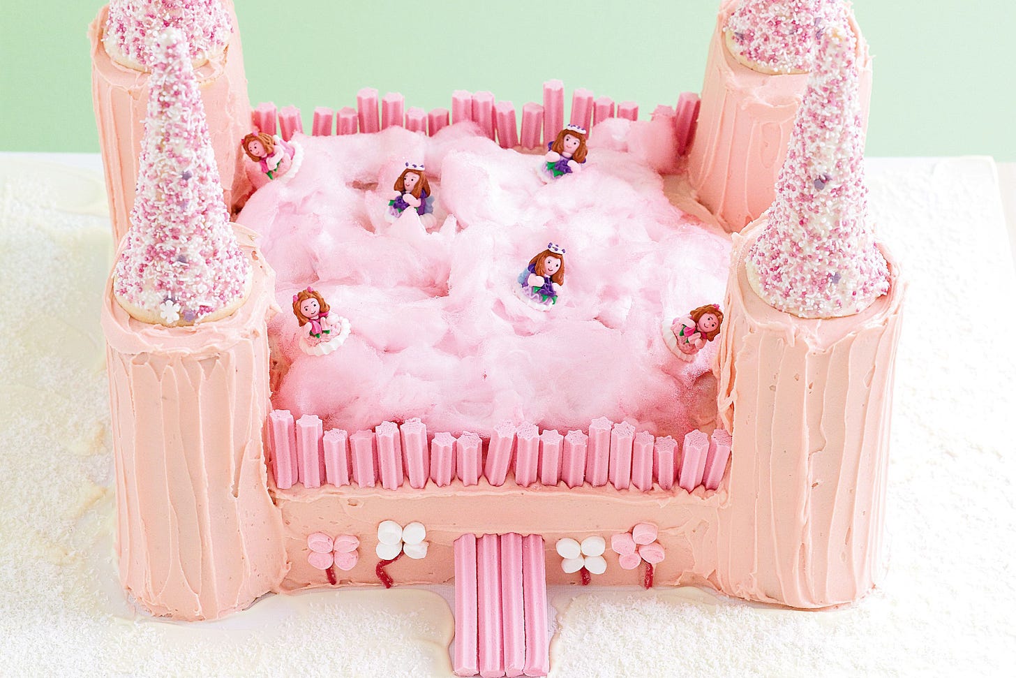 A rough and ready fairy cake. It is pink with candyfloss in the middle and little princesses. 