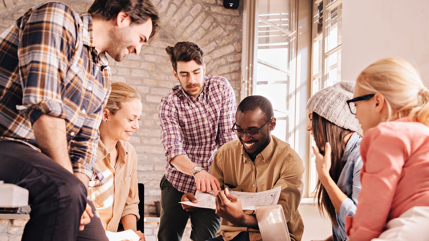 A diverse group of engaged individuals gather, symbolizing the vibrant community at 'Joining Forces for Impactful Change.' Their interaction represents the collective effort to unlock exclusive insights and in-depth analysis, embodying the active pursuit of a brighter future through shared knowledge and impactful action.