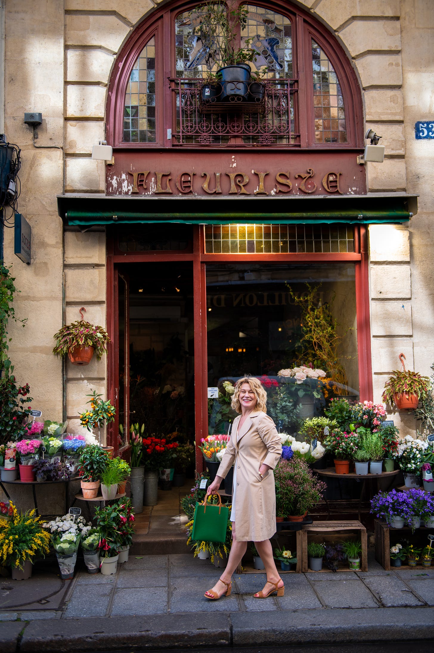 Karen Bussen walks past a florist shop in Paris