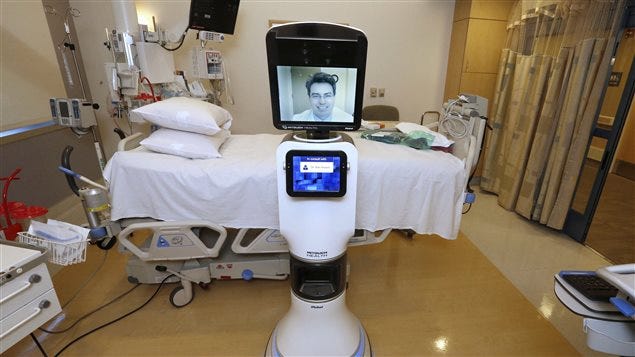 In this photo taken Wednesday, Nov. 6, 2013 Dr. Alan Shatzel, medical director of the Mercy Telehealth Network, is displayed on the monitor RP-VITA robot at Mercy San Juan Hospital in Carmichael, Calif. 