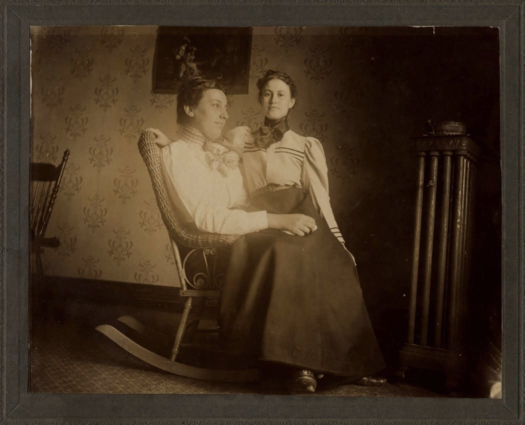 two women on a rocking chair two women on a rocking chair