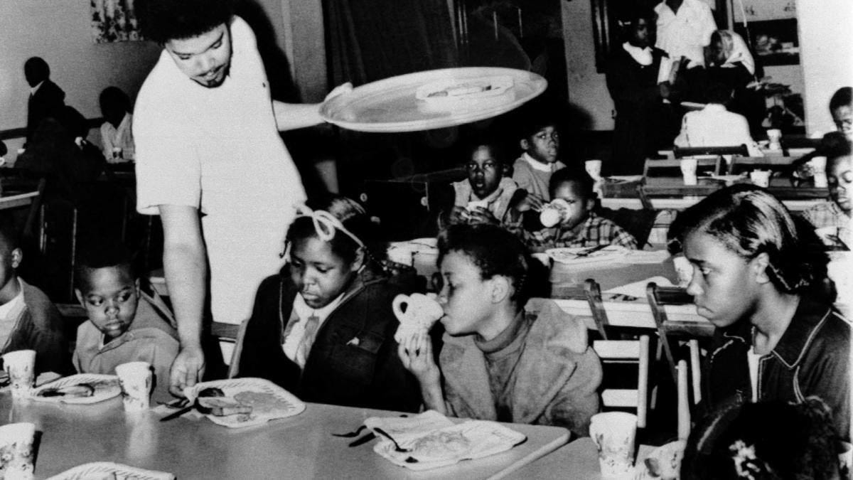 Bill Whitfield, member of the Black Panther chapter in Kansas City, serving free breakfast to children before they go to school. (Credit: William P. Straeter/AP Photo)