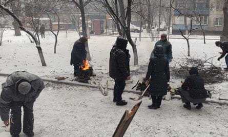 Residents cook food on fires outside their flats in March 2022.