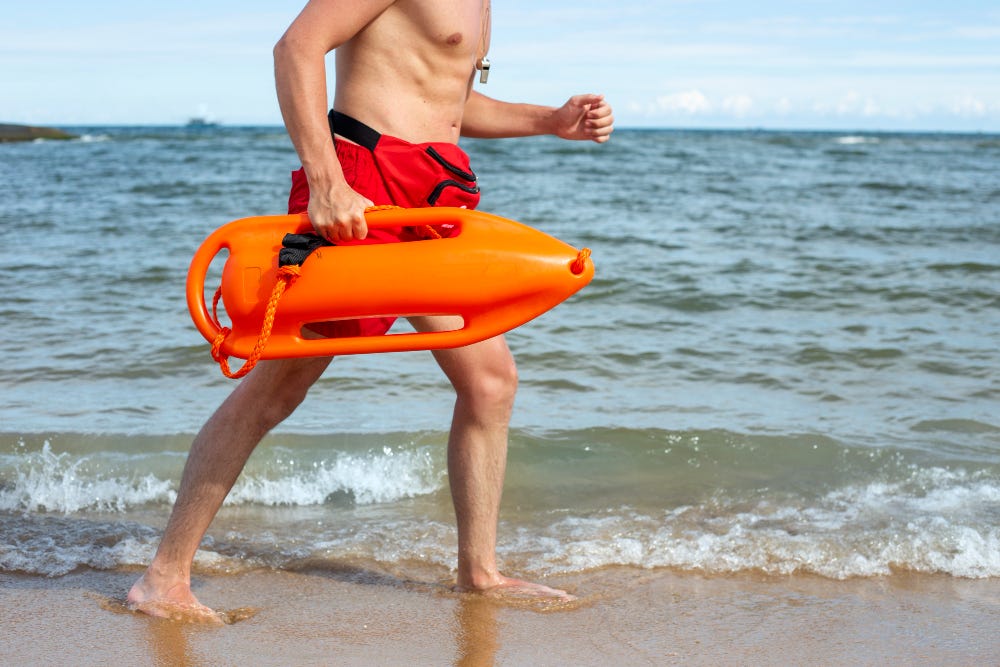 Lifeguard running on a beach.