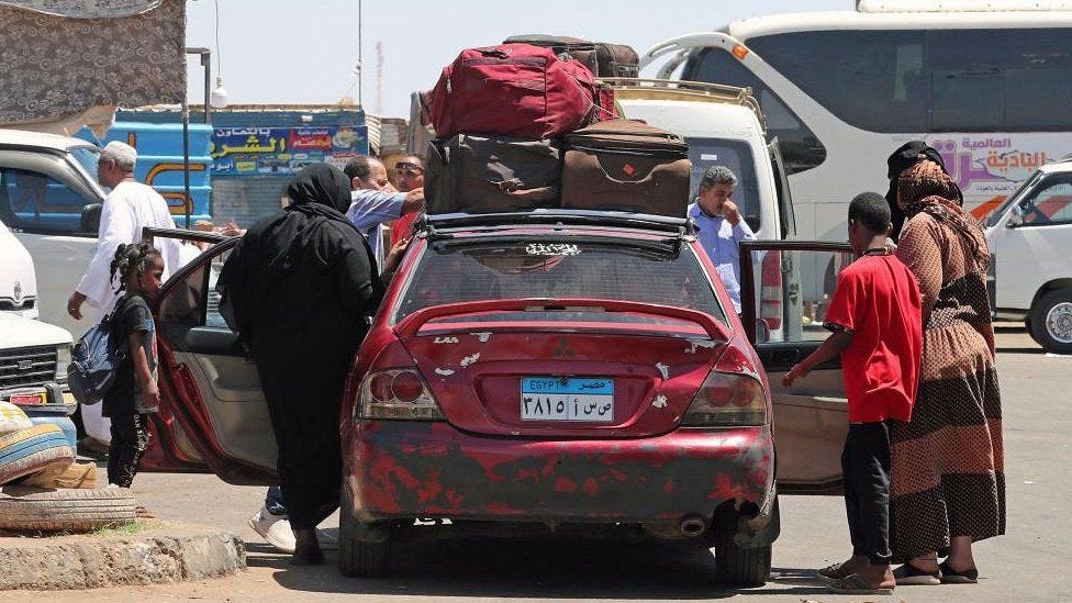 People fleeing Sudan arrive at Wadi Karkar bus station in Aswan, southern Egypt