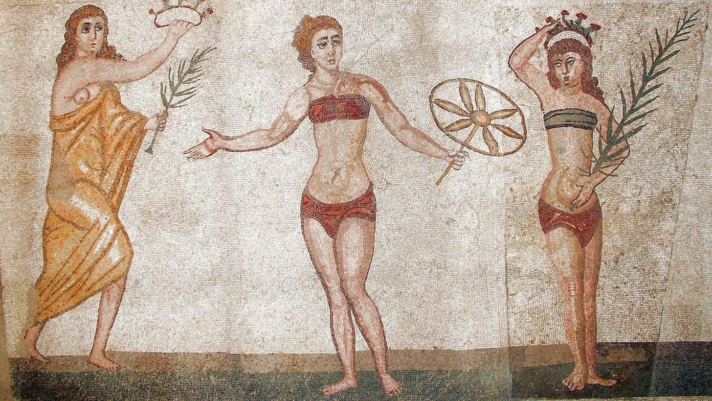 Mosaic of three women. The figure on the left wears a yellow draped cloth; the other two wear breastbands and loincloths.