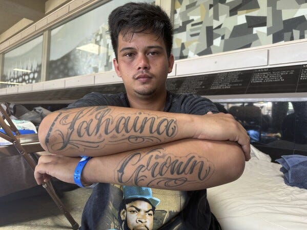 Richy Palalay, who was born and raised in the Hawaii town of Lahaina on the island of Maui, shows his "Lahaina Grown" tattoo at an evacuation shelter in Wailuku, Hawaii, Saturday, Aug. 12, 2023. There's concern that any homes rebuilt after a wildfire that tore through Lahaina will be targeted not at homegrown residents who give the town its spirit and identity but instead affluent outsiders seeking a tropical haven. That would turbo-charge what is already one of Hawaii's gravest and biggest challenges: the exodus and of Native Hawaiian and local-born residents who can no longer afford to live in their homeland. (AP Photo/Audrey McAvoy)