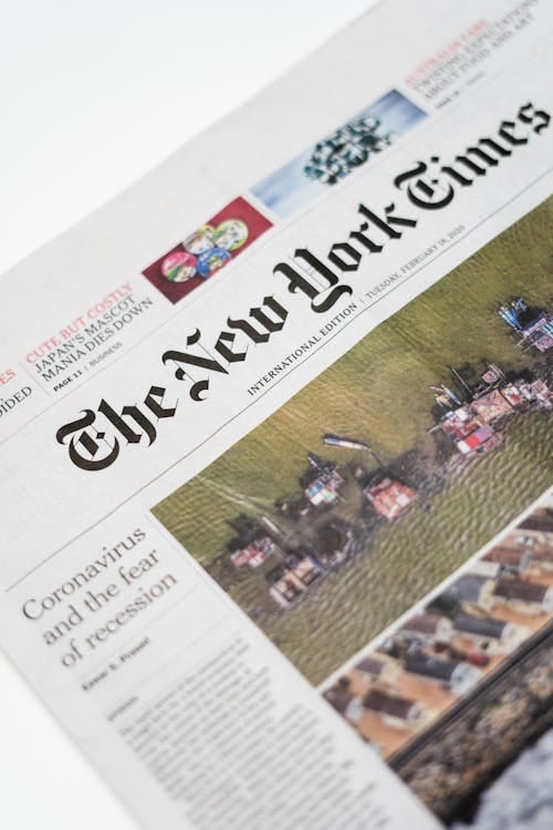 Free Detailed shot of New York Times newspaper featuring coronavirus and recession headline. Stock Photo