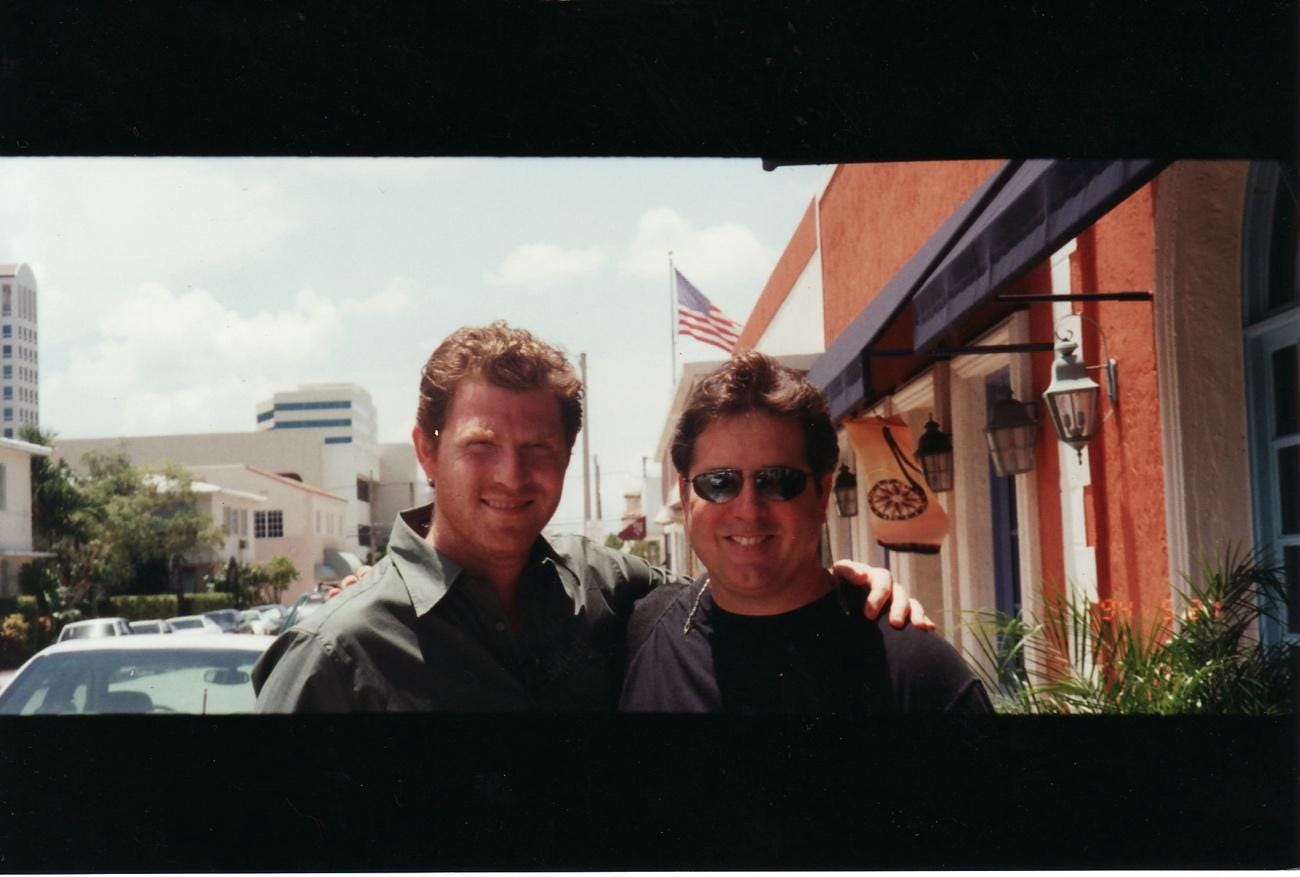 A couple of men posing for a picture

AI-generated content may be incorrect.