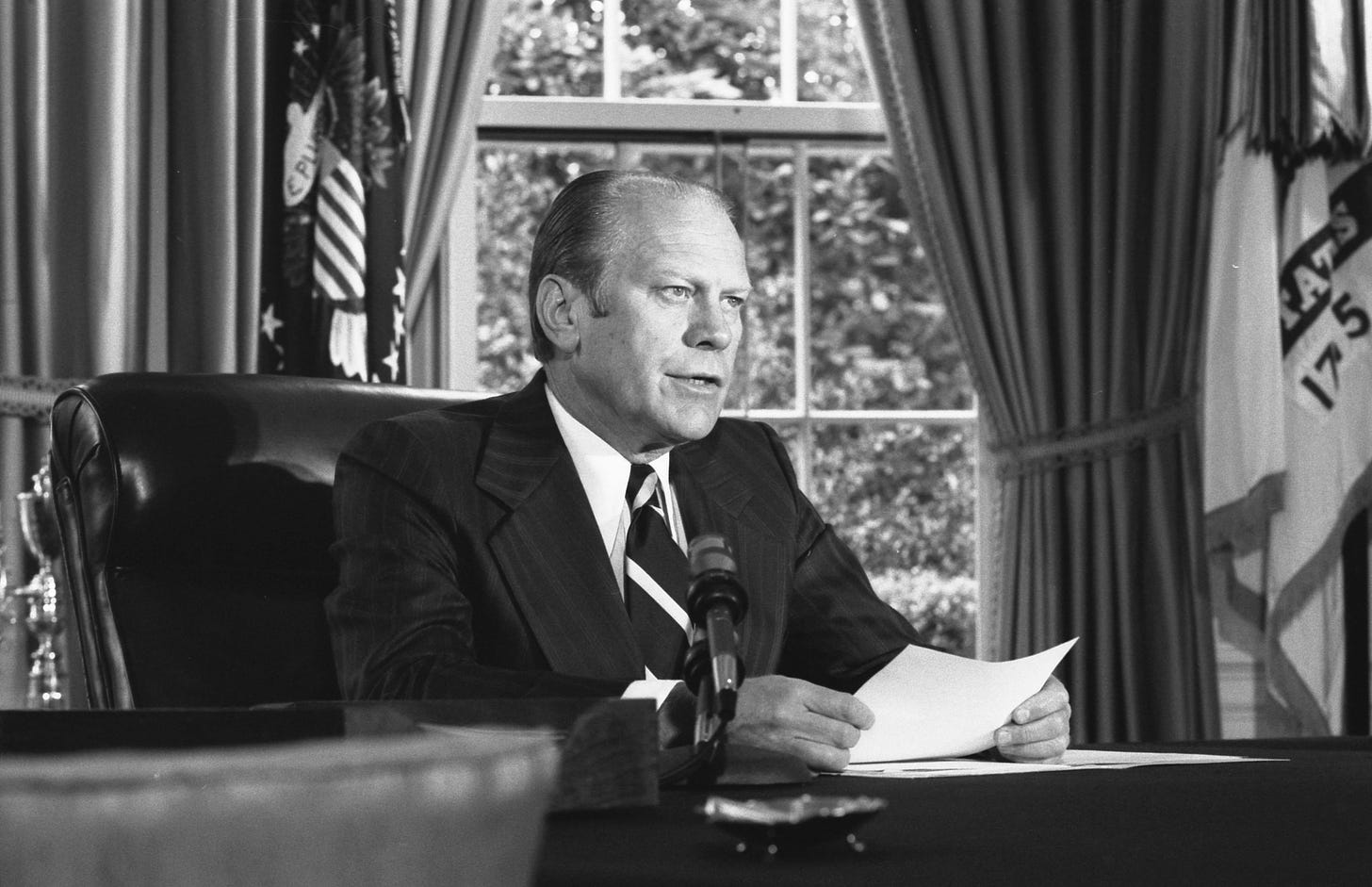 Ford sits at his desk and addresses the nation.