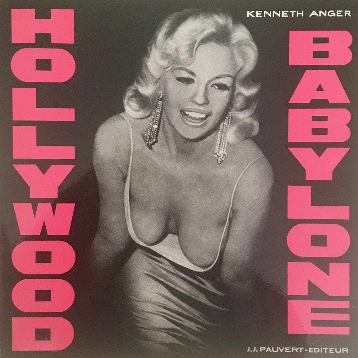 Front cover from the first French edition of Kenneth Anger's 1965 book Hollywood Babylone. The book's title in pink boldface lettering over a black and white photograph of Jayne Mansfield in a low-cut dress