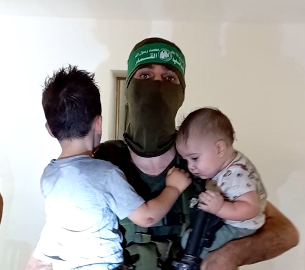 Picture of Hamas fighter holding two children 