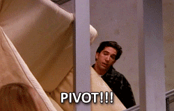 Ross from Friends carrying a couch around the corner of a stairway, yelling at Chandler and Rachel to PIVOT!!