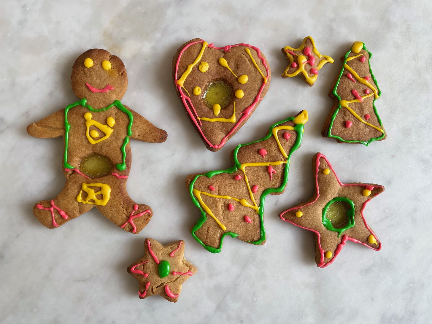 Gingerbread biscuits with decorative coloured icing, gingerbread man, christmas tree, love heart and star