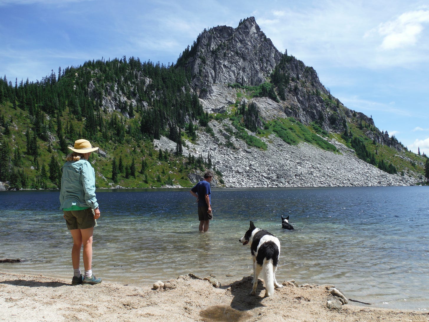 Couple & dogs enjoying an alpine lake