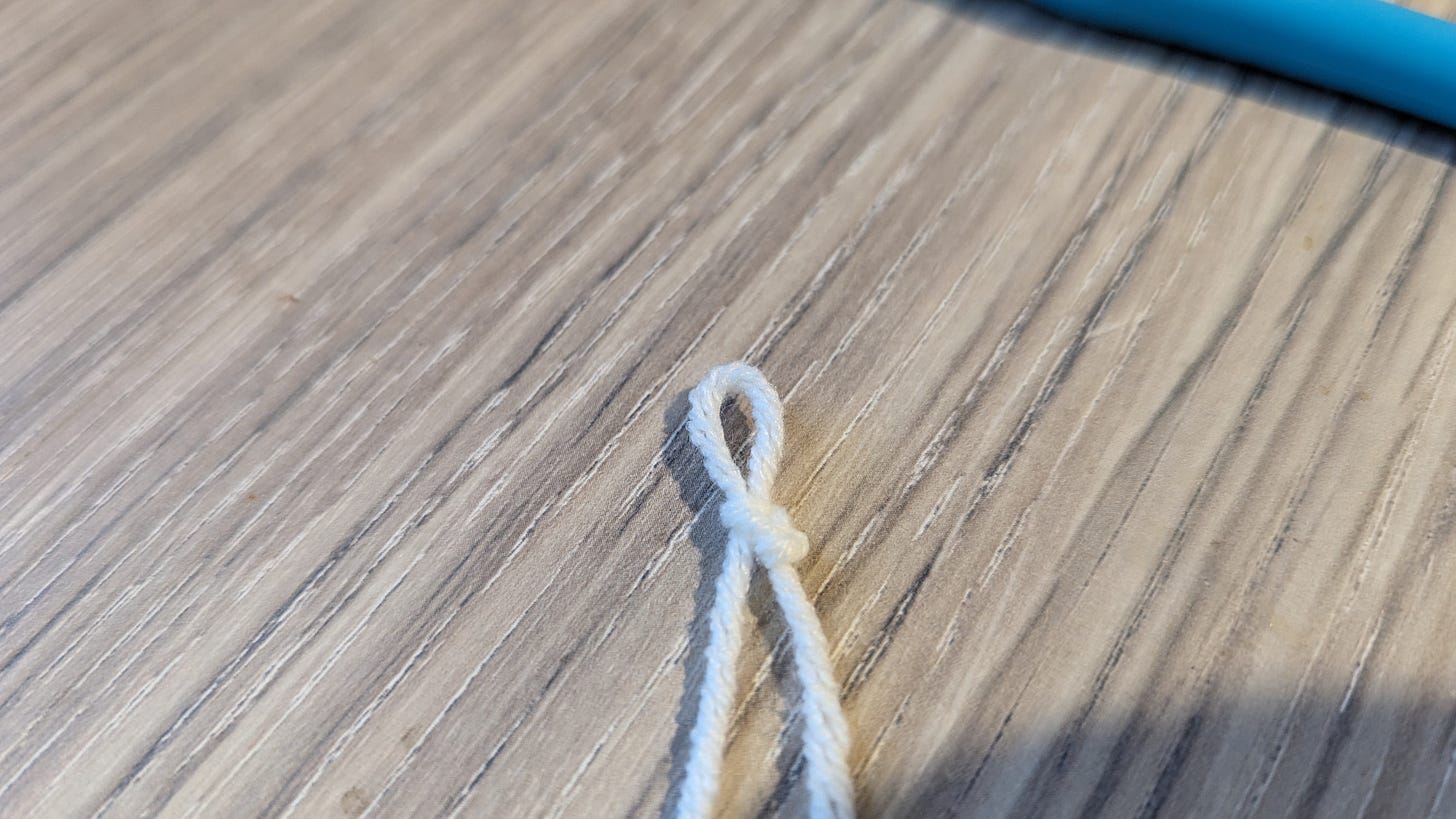 a loop of yarn with one bump/knot on the left and two bumps on the right