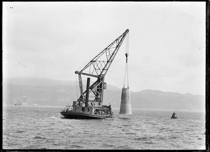 Floating crane Hikitia lowering concrete base for Point Jerningham lighthouse, Wellington harbour