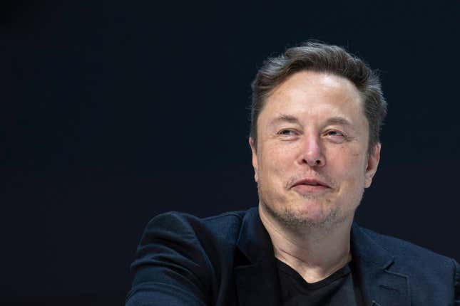 Close-up of Elon Musk's face as he speaks, background is solid black