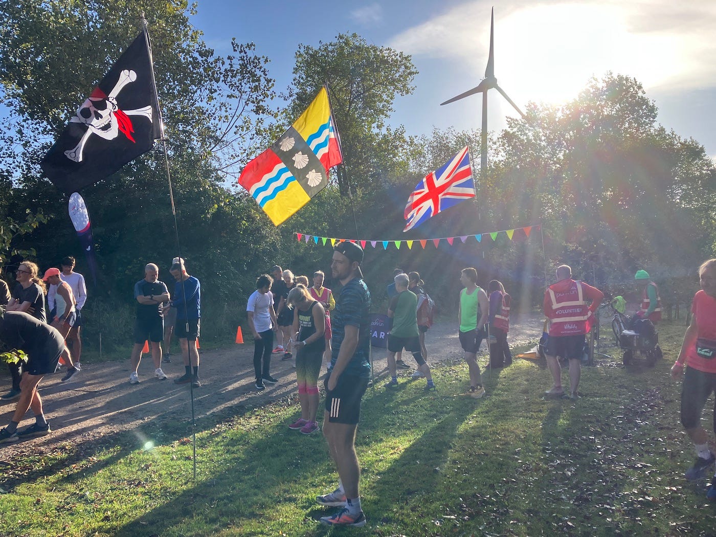 Several colourful flags and bunting suspended at the start
