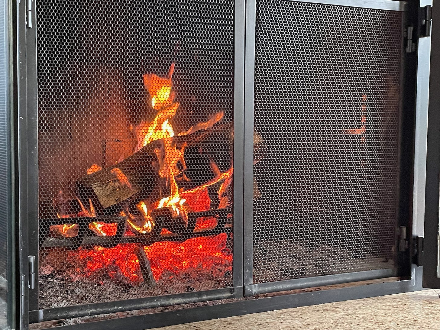 When this fireplace is fully loaded, it threw off enough heat to melt the silicone used to adhere the glass to the doors.