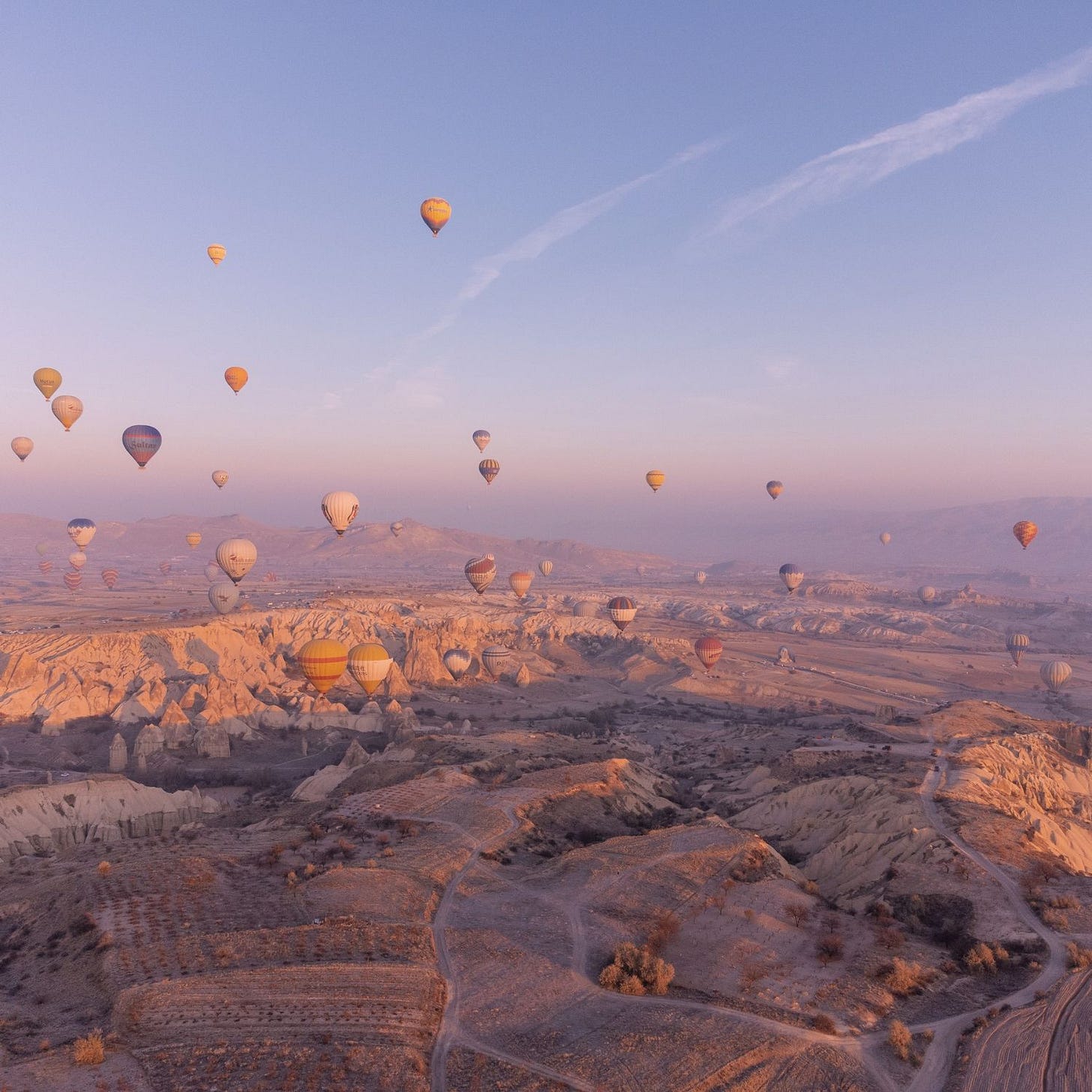 Hot air balloons in the sky over mountain landscape