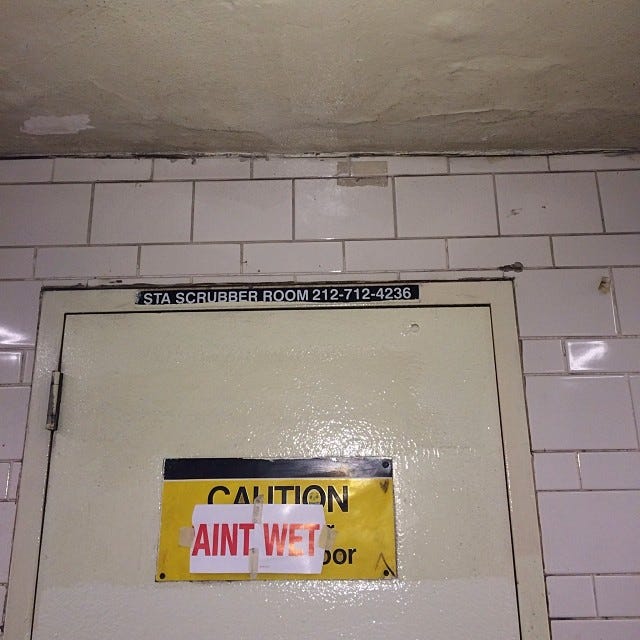 A wet paint sign has been vandalized to accurately read “ain’t wet” instead.