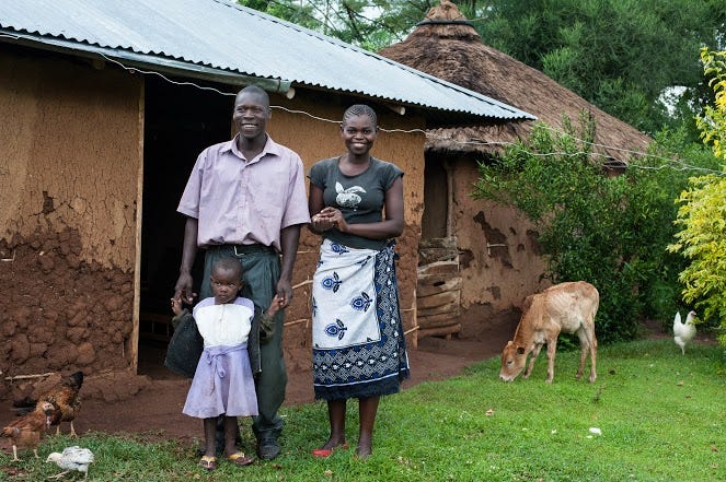 At the home of recipient Gabriel Otieno Awoche in Koga village on 22 October 2014. Gabriel built a house and chicken coop with the cash. He also bought woodworking tools for his furniture workshop. Gabriel with his wife Lucy Adhiambo and their daughter Charlotte, 3. They also have another daughter, Mariam, age 1 1/2. At the home of recipient Gabriel Otieno Awoche in Koga village on 22 October 2014. Gabriel built a house and chicken coop with the cash. He also bought woodworking tools for his furniture workshop. Gabriel with his wife Lucy Adhiambo and their daughter Charlotte, 3. They also have another daughter, Mariam, age 1 1/2.