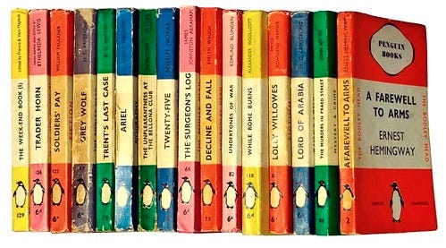 Vintage Penguin paperback books in various colors lined up side by side, featuring titles like 'A Farewell to Arms' by Ernest Hemingway. Vintage Penguin paperback books in various colors lined up side by side, featuring titles like 'A Farewell to Arms' by Ernest Hemingway.