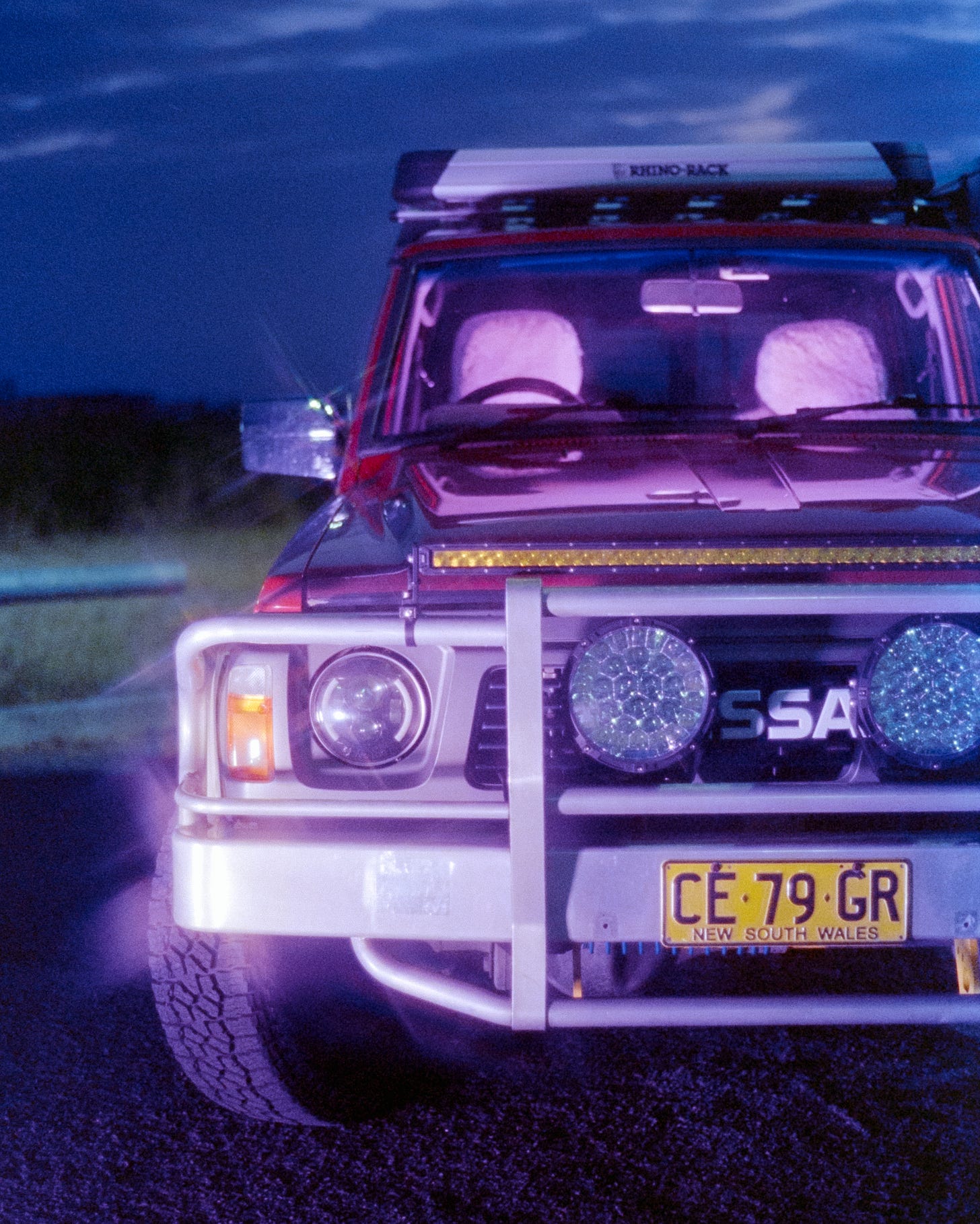 A glowy purple close up image of Josie's 1991 GQ Patrol. She used purple lights and a cross screen filter to purposely make the light shine back like little stars