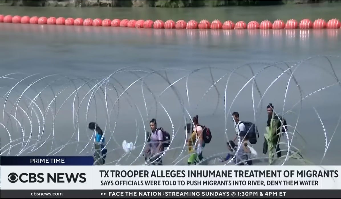 CBS News video screenshot of migrants wading along northern bank of Rio Grande.  Razor wire in foreground, floating barrier buoys in river in background. Chyron: "TX trooper alleges inhumane treatment of migrants; says officials were told to push migrants into river, deny them water