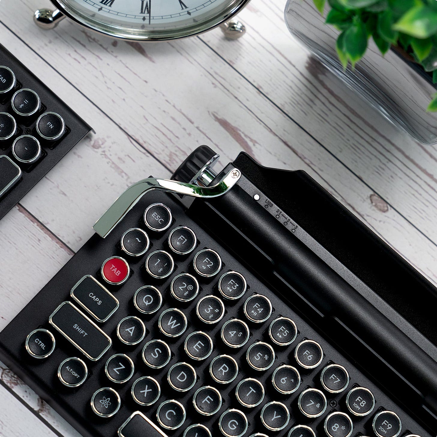 a black and chrome keyboard thsat looks like a typewriter