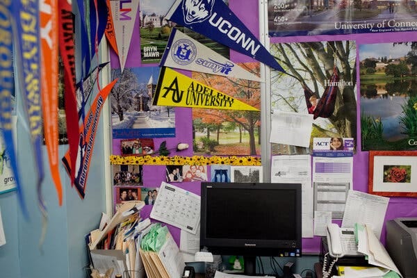 Flags and posters promoting hundreds of colleges at the counseling office of a high school in Brooklyn. 