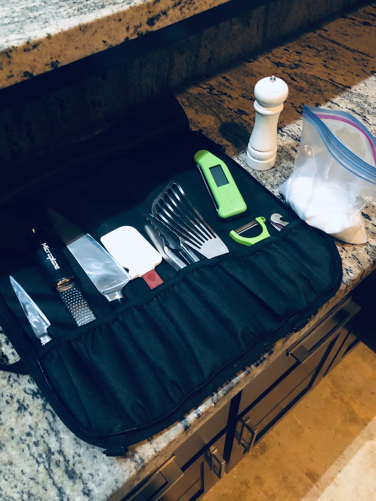 My knife roll, opened on a kitchen counter on a trip to Costa Rica, as described in the caption.