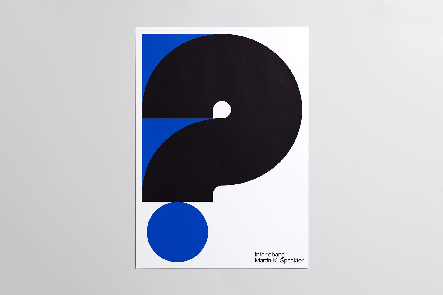 Poster of a blue and black interrobang, designed by Martin K. Speckter