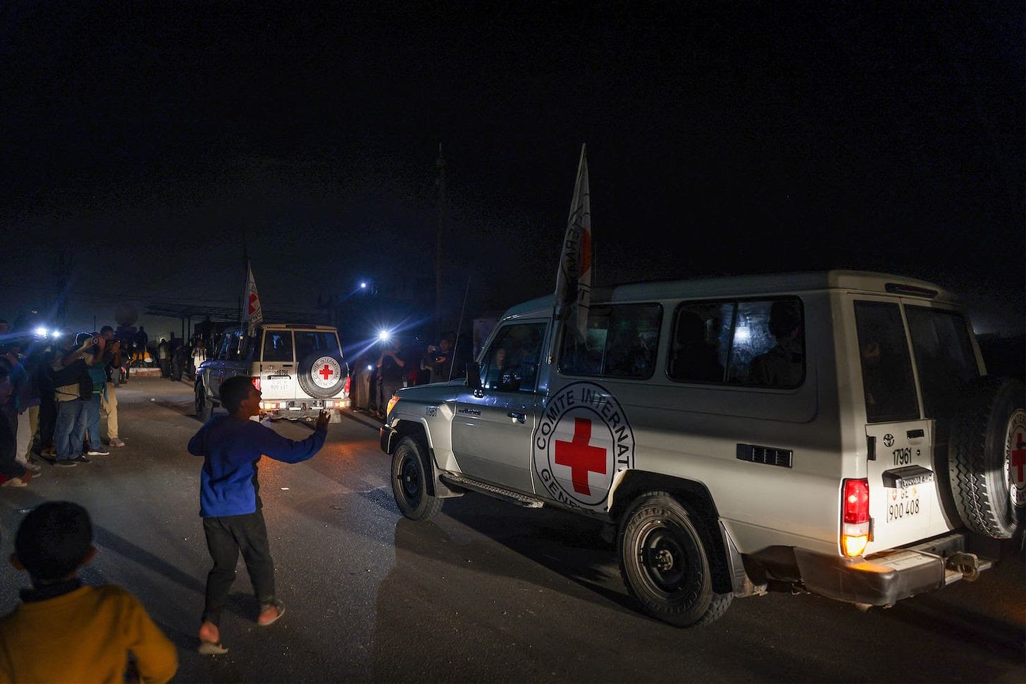International Red Cross vehicles reportedly carrying hostages released by Hamas cross the Rafah border point in Gaza on the way to Egypt from which they would be flown to Israel to be reunited with their families, on Nov. 24.