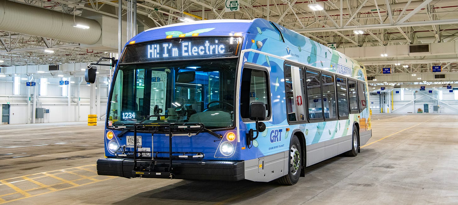 Electric bus inside the Northfield garage, with "Hi! I'm Electric" on the destination sign