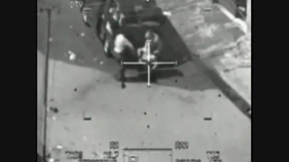 An image taken from classified US military footage shows a wounded Iraqi person being loaded onto a van during a 2007 attack by Apache helicopters, as released to Reuters on April 5, 2010 by WikiLeaks. - WikiLeaks/Reuters