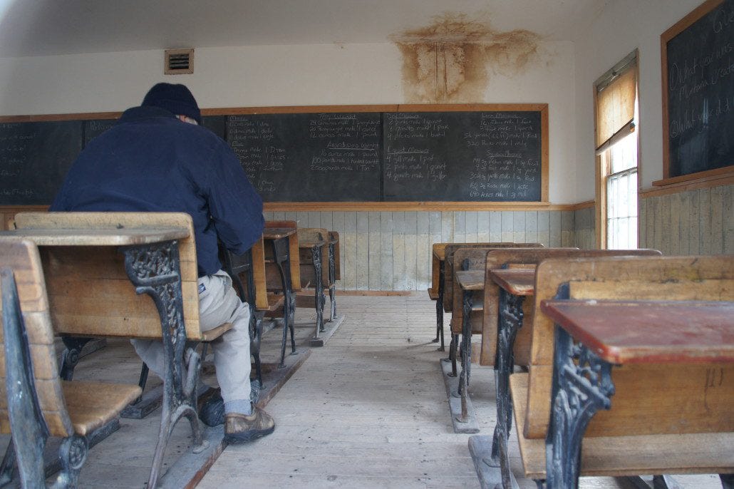 My dad sits in the old schoolhouse.