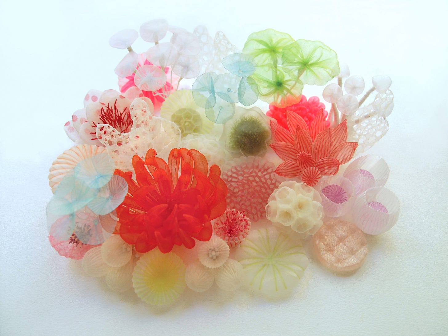 A lightweight bracelet made from airy textile shapes that look like coral.