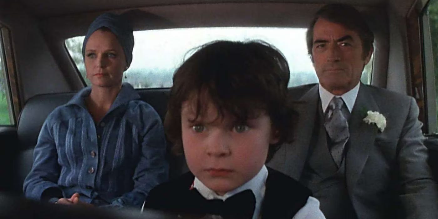  The Antichrist Damien sits between Gregory Peck and Lee Remick in a car in the 1976 The Omen. 