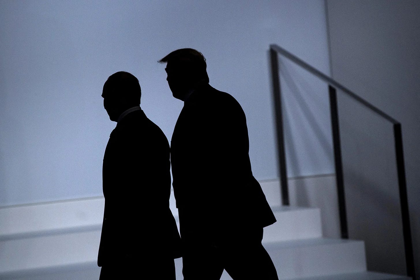 Putin and Trump are shown as silhouettes walking in front of a low set of steps at a summit.