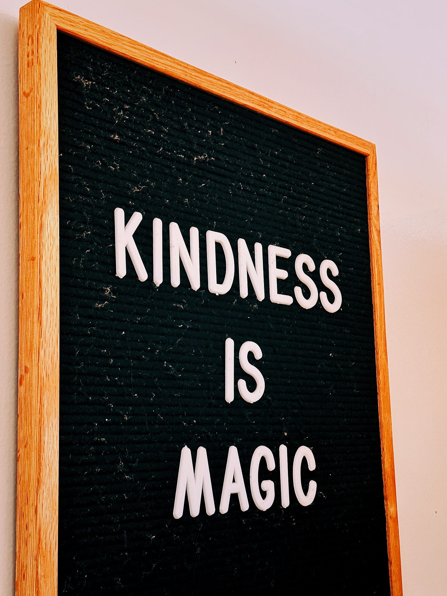 A framed message board that says "kindness is magic"