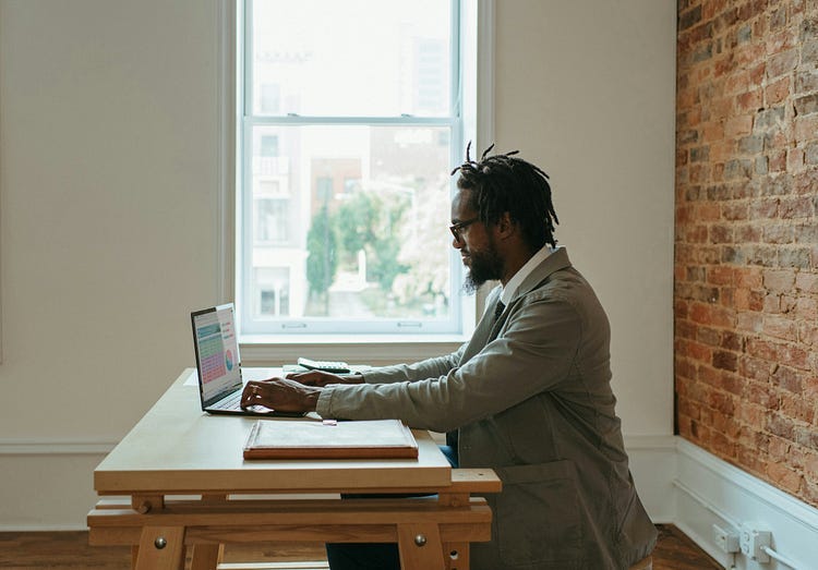 Man typing on laptop.