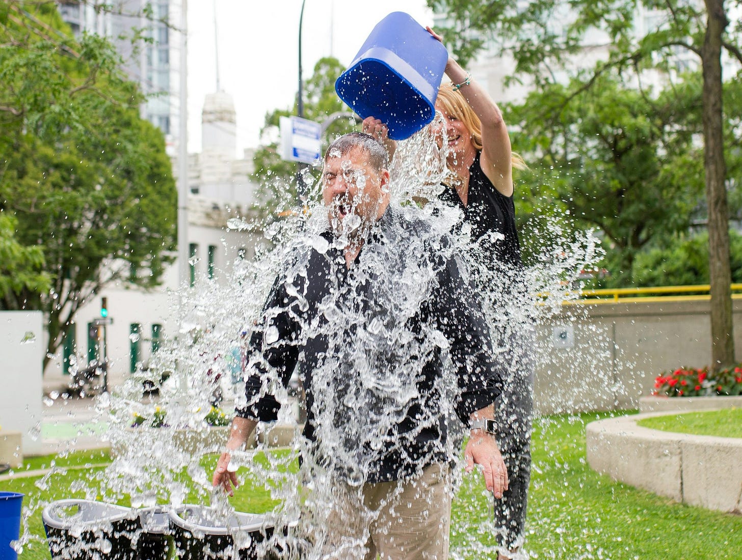 person pouring water to man