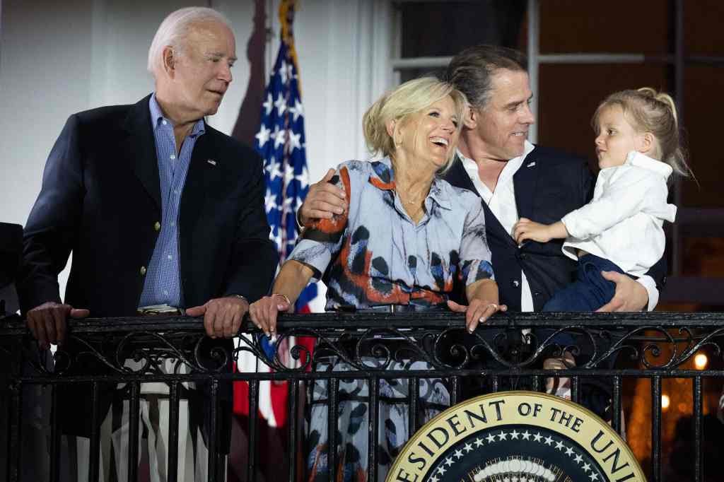 US President Joe Biden, First Lady Jill Biden and Hunter Biden with his son Beau watch the Independence Day fireworks display from the Truman Balcony of the White House.