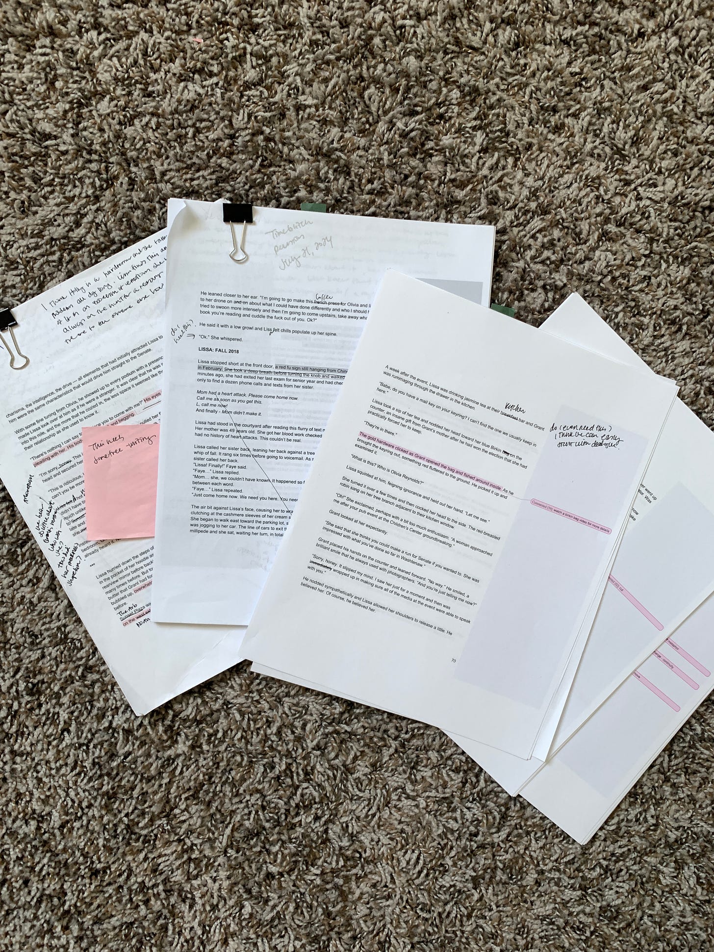 stacks of paper on the carpet with black pen used for editing