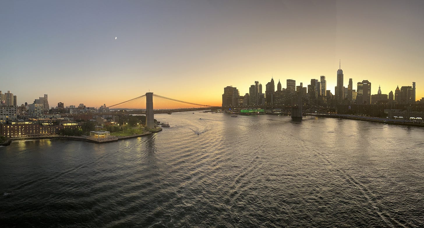 A sunset picture of the Brooklyn Bridge connecting Manhattan and Brooklyn
