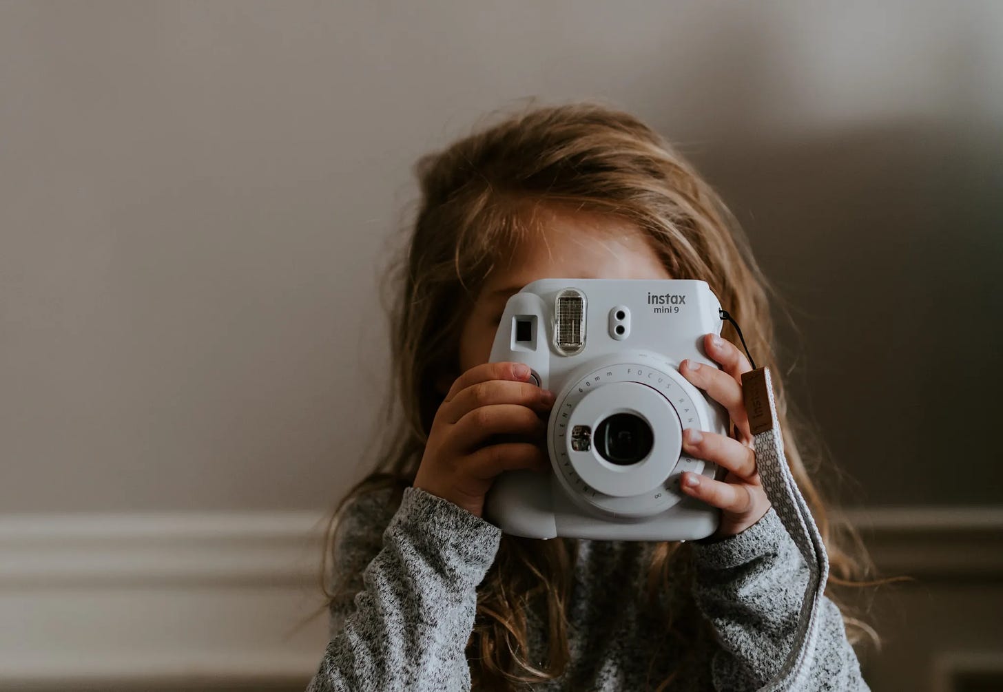 A child holding a camera

Description automatically generated