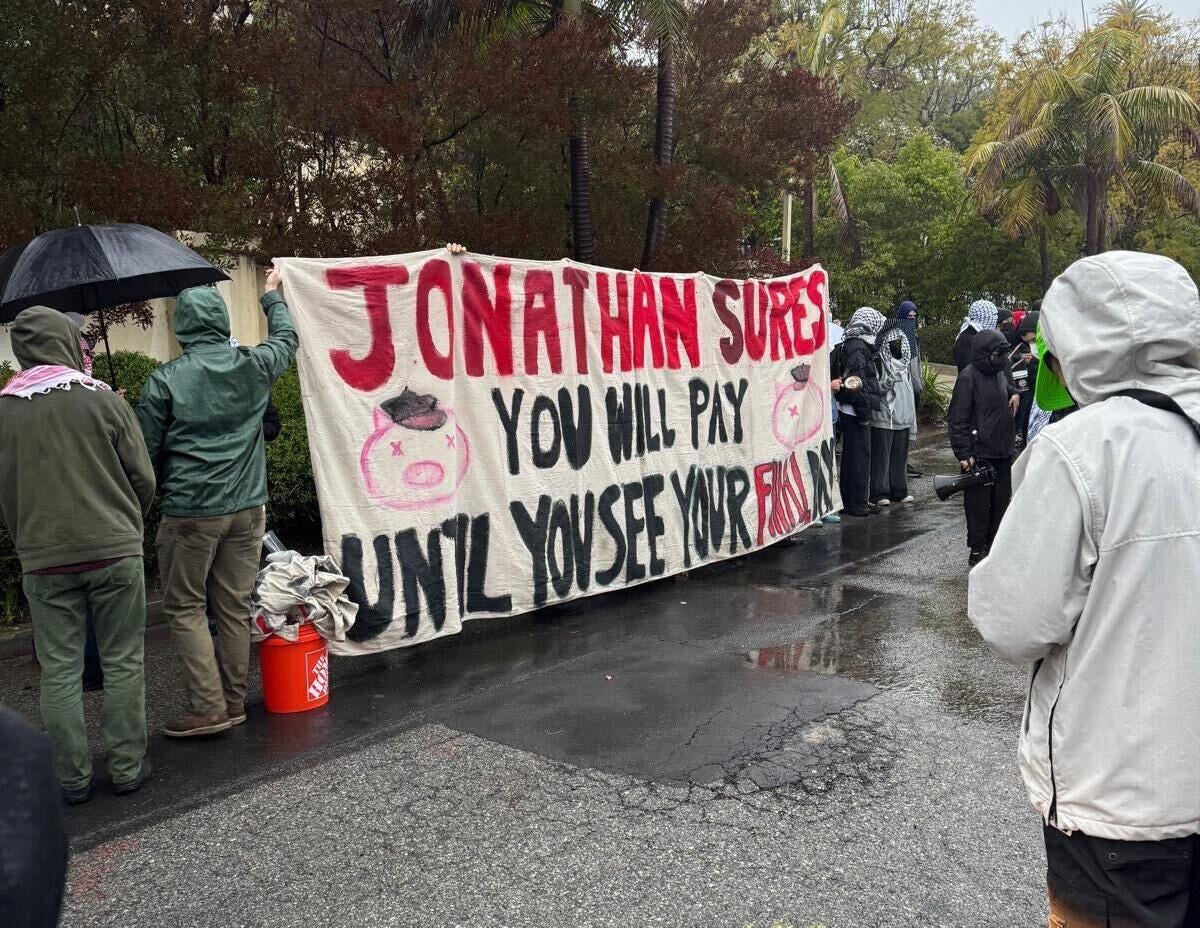 Students for Justice in Palestine protest along a residential street.